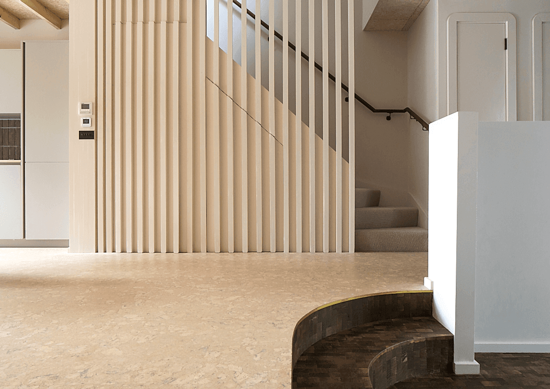 Light Cork flooring in a contemporary hallway with slatted timber feature wall